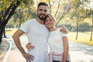 A couple hugging in the park. Represents how therapy for high functioning autism in orange county, ca can support women with autism in orange county, ca with dating.