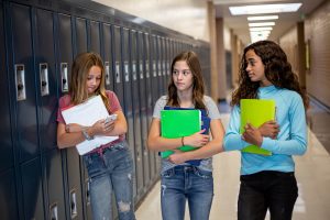 Group of students in a hallway with concerned expressions. Teen with autism is twice exceptional. She wants to make friends and works on these social skills in asperger teen counseling palo alto, ca at Open Doors Therapy. Search for autism teen therapy Silicon Valley to learn more.